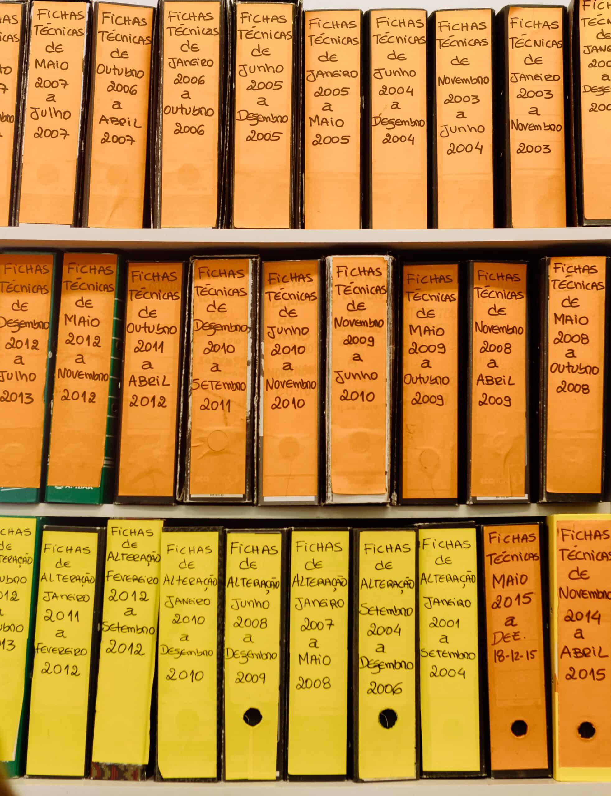 Rows of labelled binders on a shelf